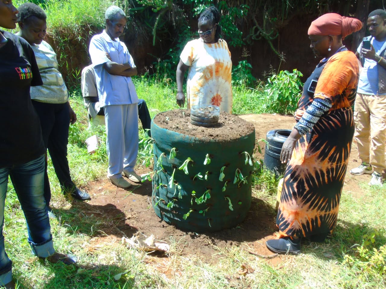 Participants gathered round a finished sack garden at the training
