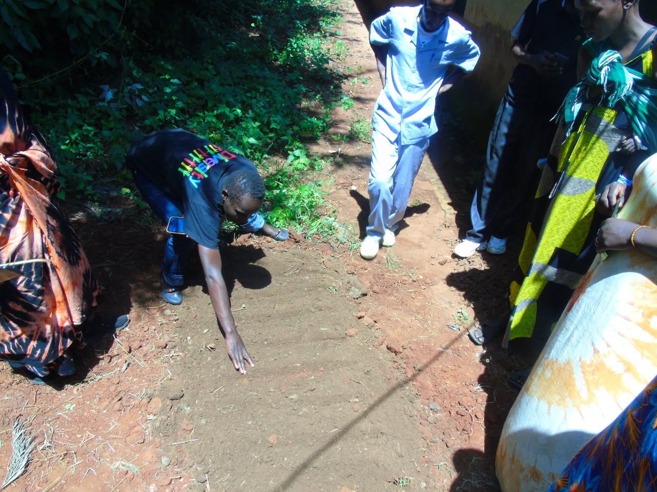 A trainer showing participants how to prepare a seedbed