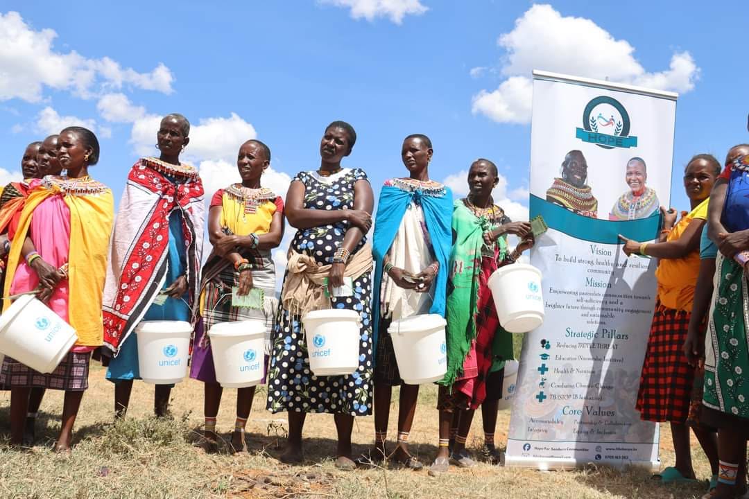 Women receive water collection buckets to improve access to safe water, strengthen household hygiene, and promote community well-being.