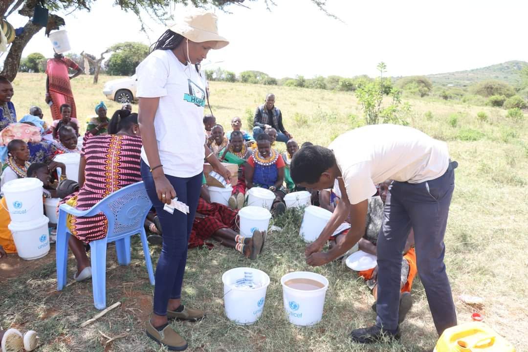 Women participate in a hands-on training session on household water treatment, gaining practical skills to ensure safe drinking water for their families.